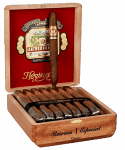 Open wooden box of Arturo Fuente Hemingway Classic cigars with red velvet lining and a single cigar on display.